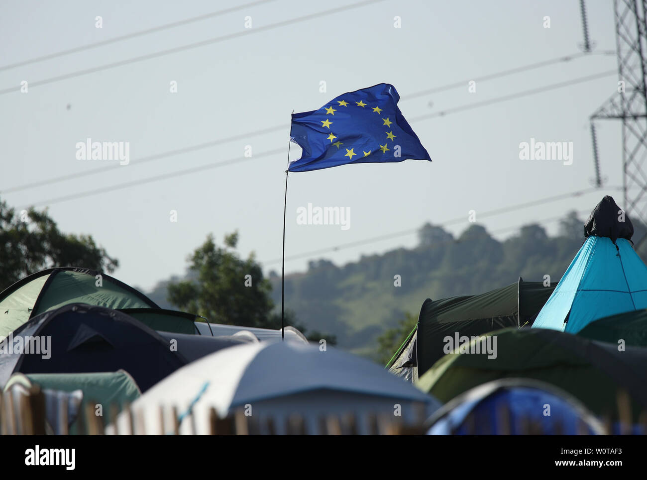 An EU flag flying above tents on the third day of the Glastonbury Festival at Worthy Farm in Somerset. Stock Photo