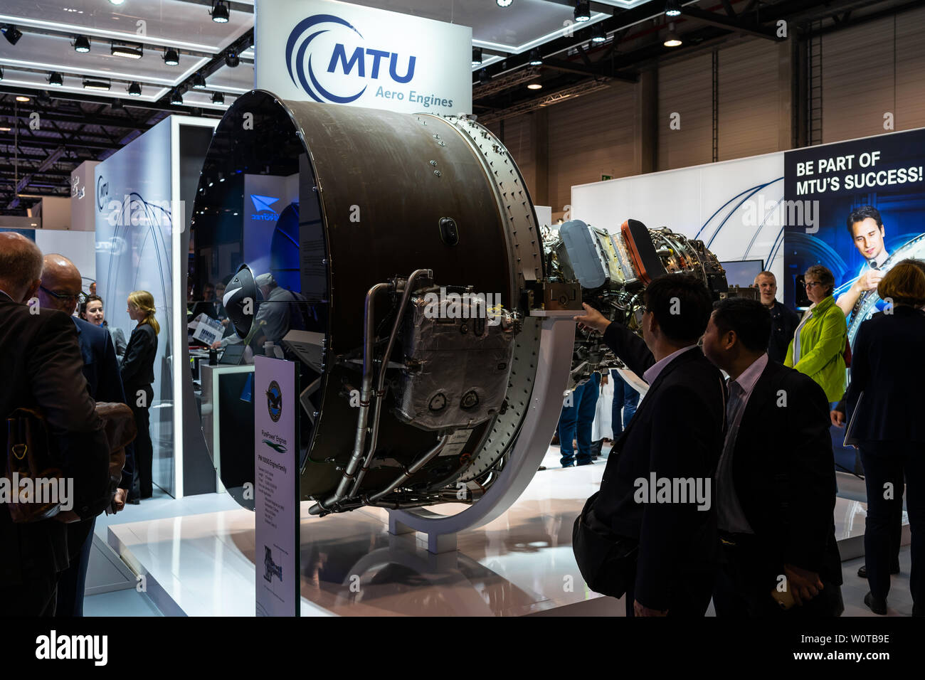 BERLIN, GERMANY - APRIL 25, 2018: The stand of MTU Aero Engines and high-bypass geared turbofan engine family Pratt & Whitney PW1000G. Exhibition ILA Berlin Air Show 2018. Stock Photo