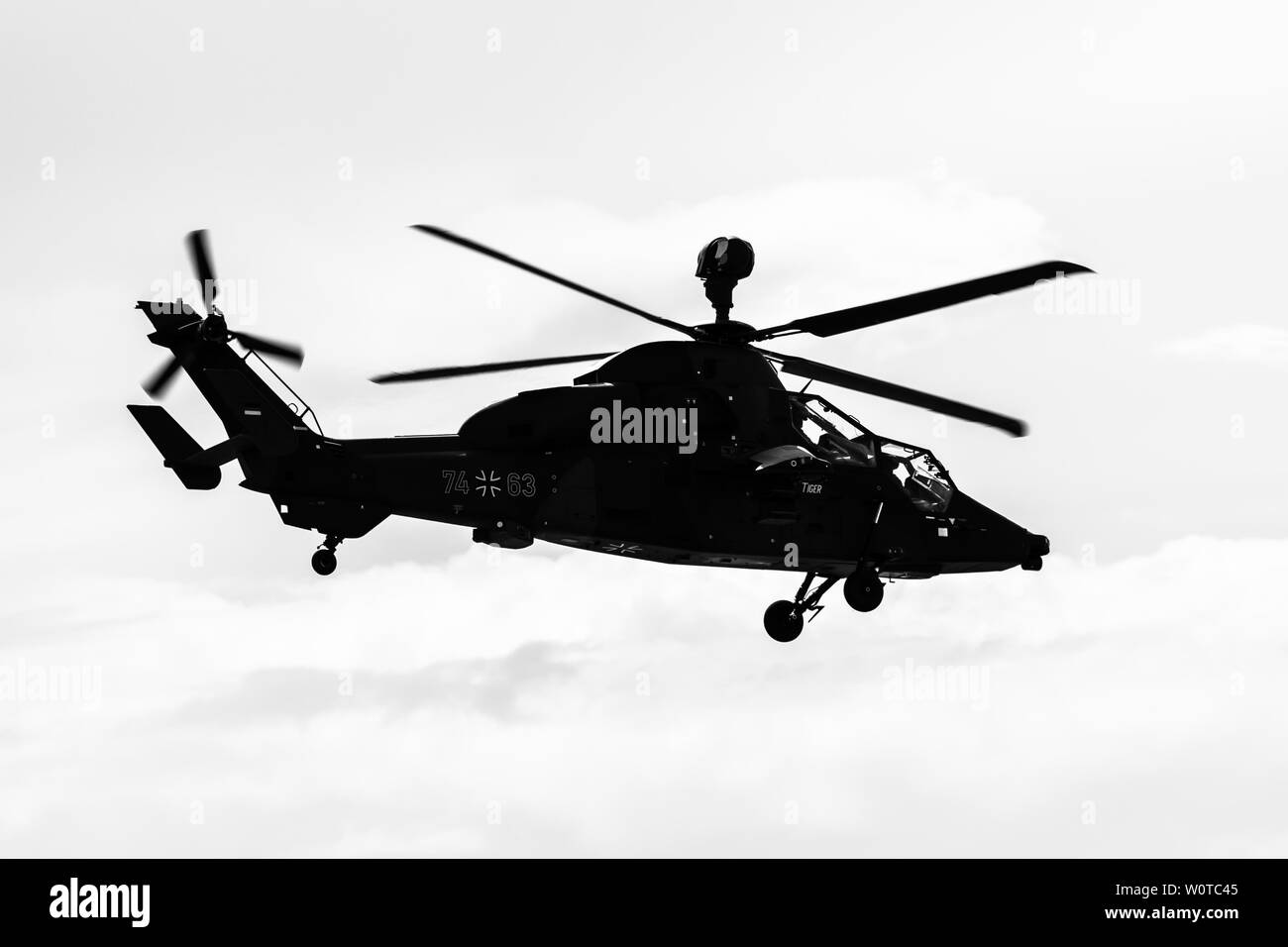 BERLIN, GERMANY - APRIL 26, 2018: Demonstration flight of attack helicopter Eurocopter Tiger UHT. German Air Force. Black and white. Exhibition ILA Berlin Air Show 2018 Stock Photo