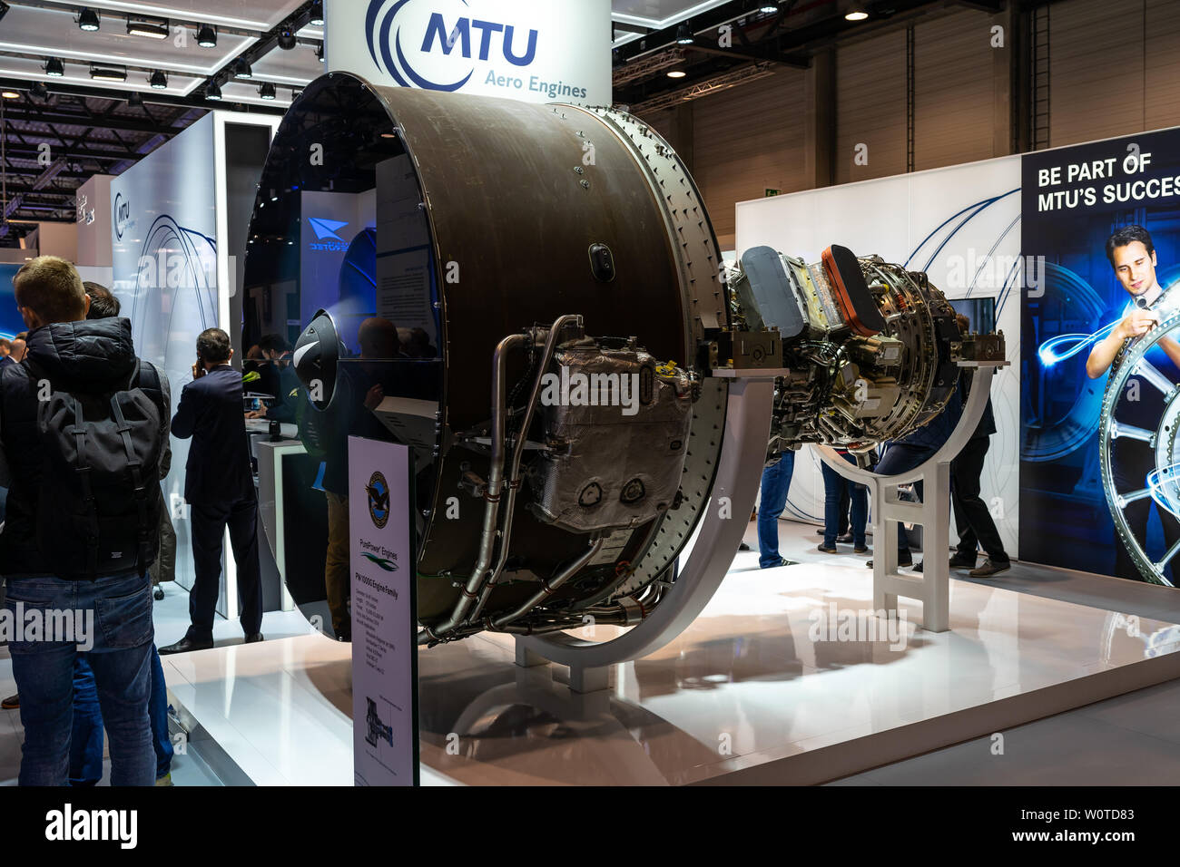 BERLIN - APRIL 26, 2018: The stand of MTU Aero Engines and high-bypass geared turbofan engine family Pratt & Whitney PW1000G. Exhibition ILA Berlin Air Show 2018. Stock Photo