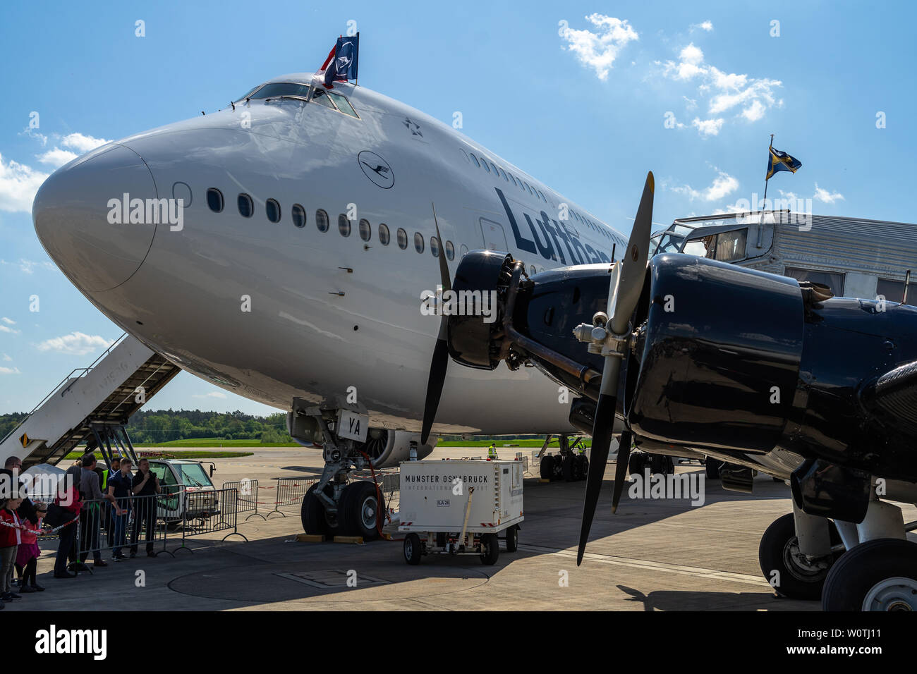 BERLIN - APRIL 28, 2018: Transport aircraft Junkers Ju 52/3m (foreground) and the widebody jet airliner Boeing 747-8 (background). Lufthansa. Exhibition ILA Berlin Air Show 2018. Stock Photo