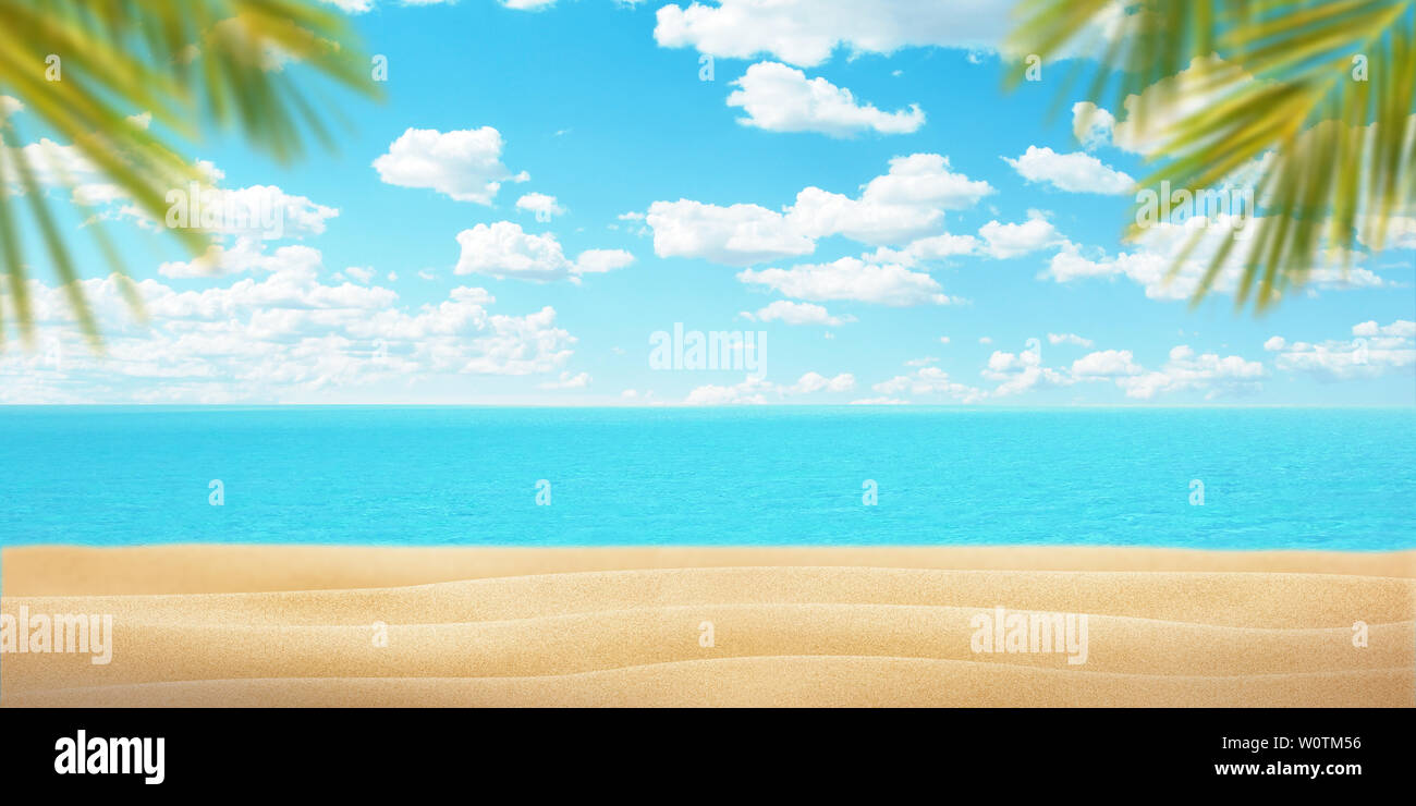 Summer beach with palm leaves. Sand, sea and blue sky with clouds. Copy space in the middle for promo text or logo. Summer travel concept. Stock Photo