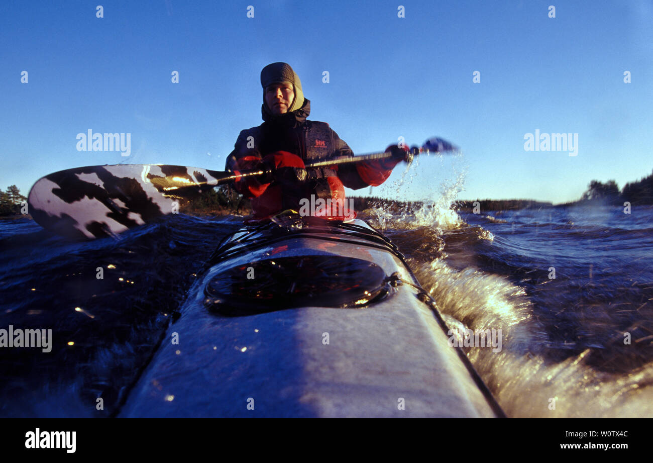 Outdoor photographer Øyvind Martinsen in his kayak on the lake Vansjø in Østfold, Norway. Vansjø is the largest lake in Østfold. The lake Vansjø and its surrounding lakes and rivers are a part of the water system called Morsavassdraget. November, 2006. Stock Photo
