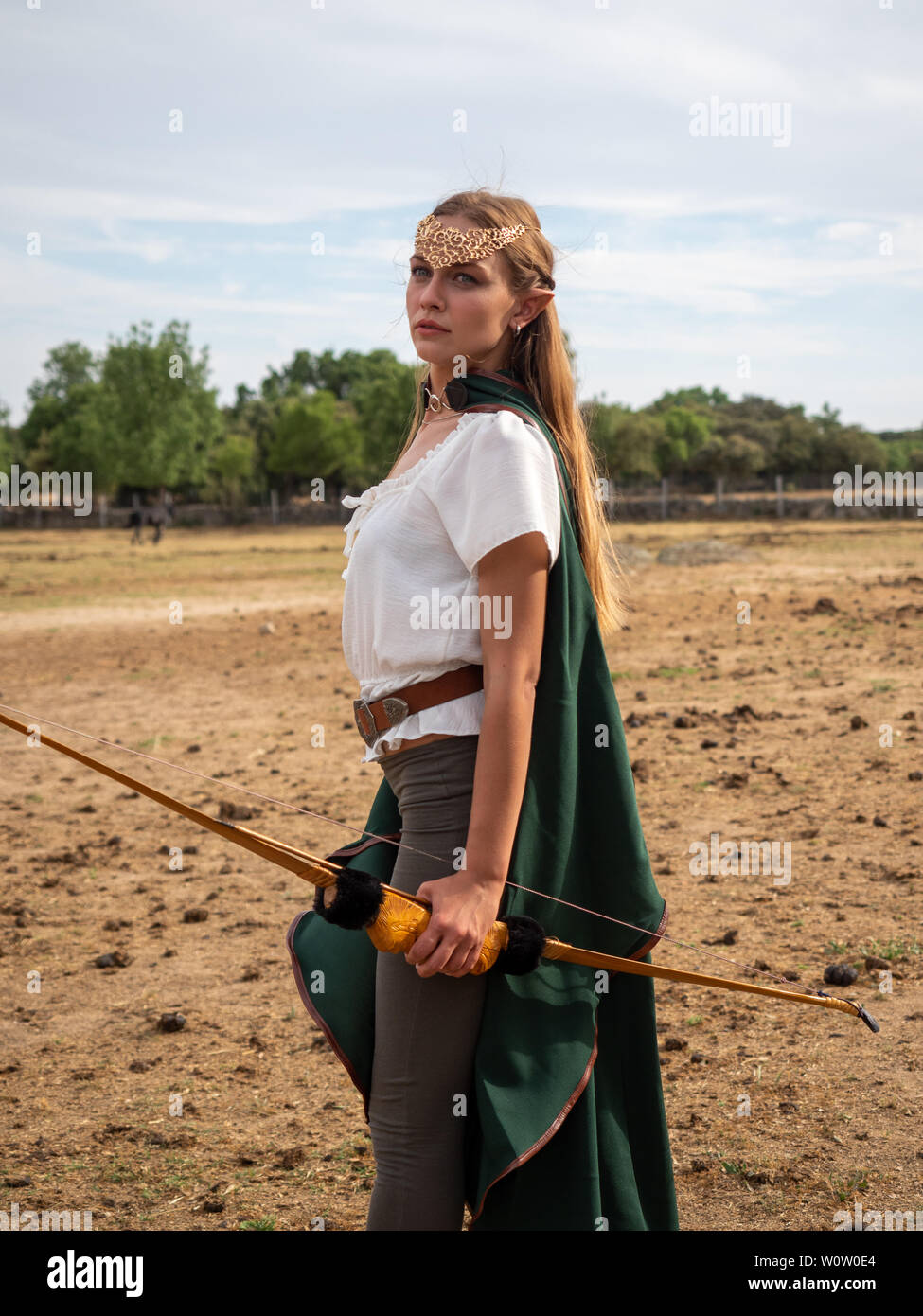 Blonde Girl With Blue Eyes And Makeup With Elf Ears Poses In The