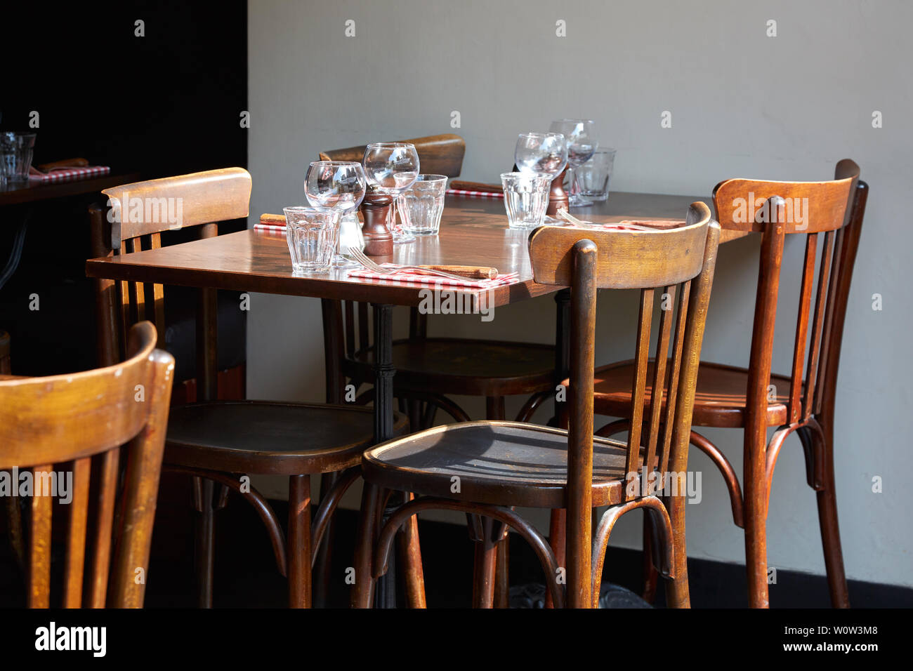 Brown wooden restaurant tables and chairs in sunny summer day Stock Photo