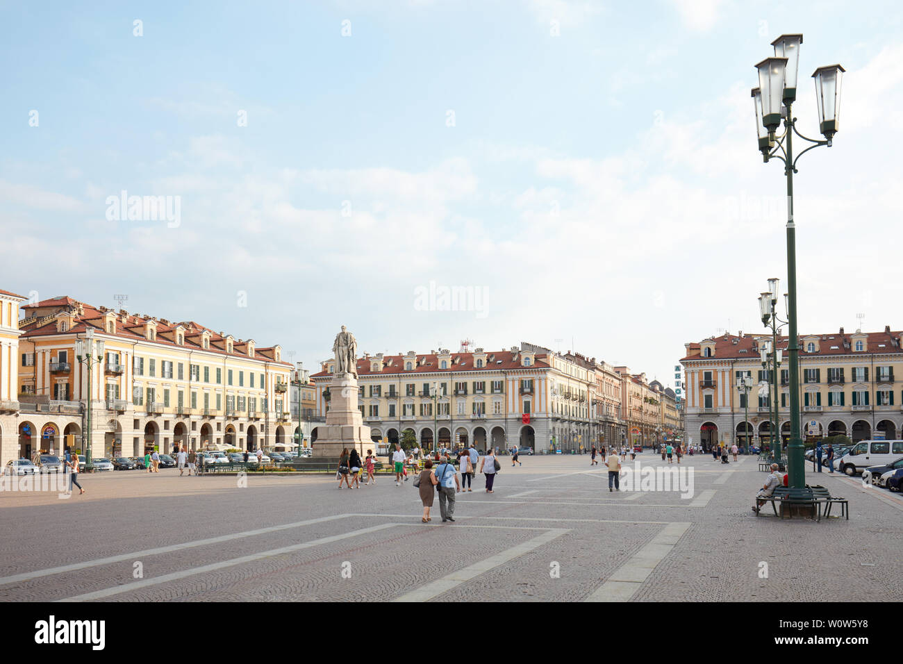CUNEO, ITALY - AUGUST 13, 2015: Galimberti square with people in a summer evening, blue sky in Cuneo, Italy. Stock Photo