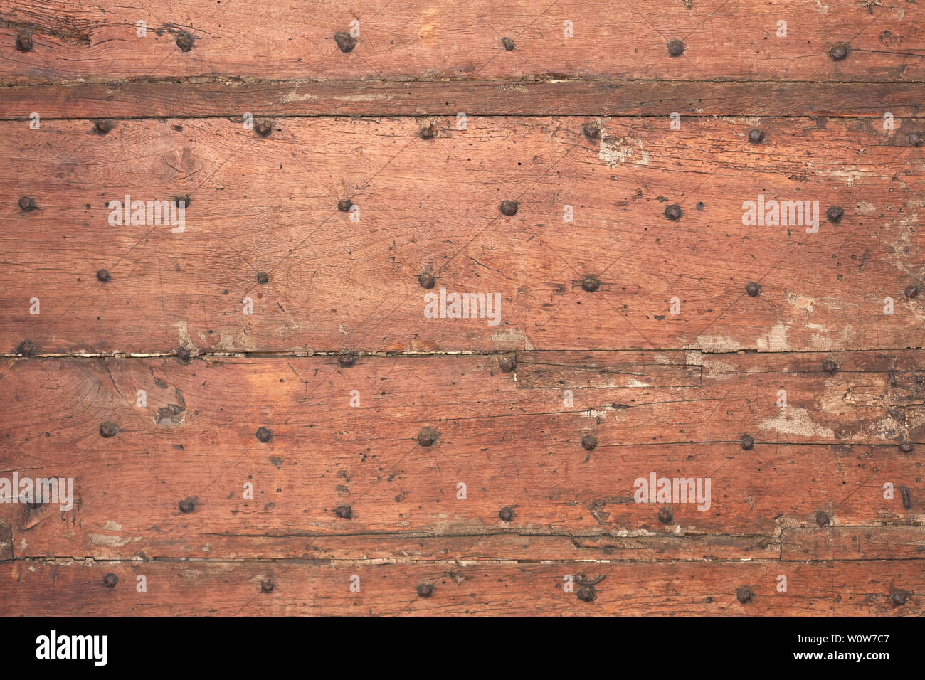 Old wooden weathered door with nails texture background Stock Photo