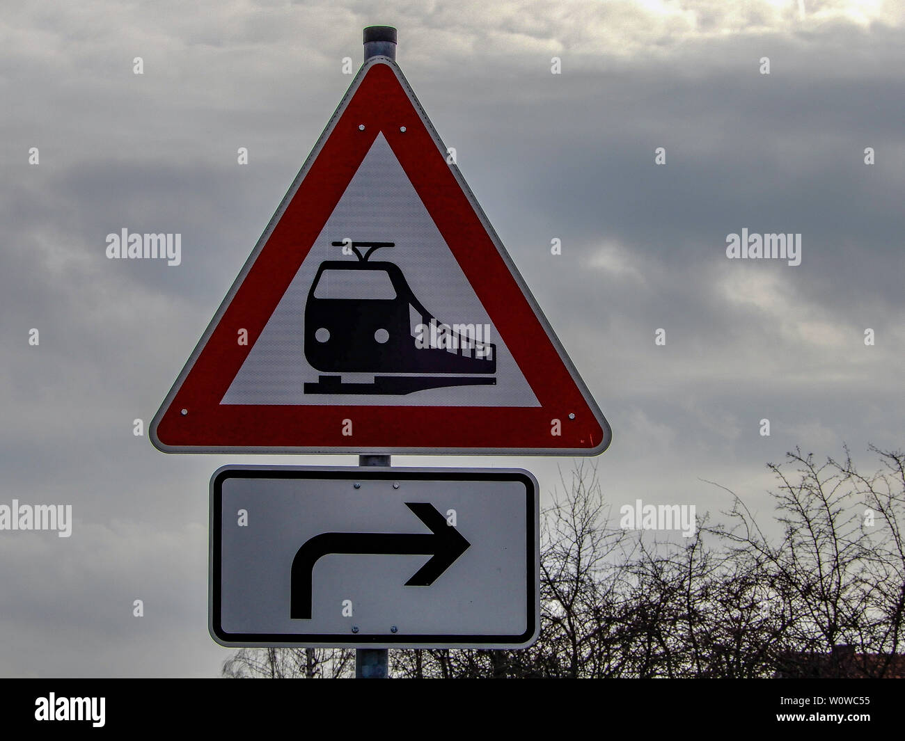 Road sign railway crossing turn right in Germany Stock Photo