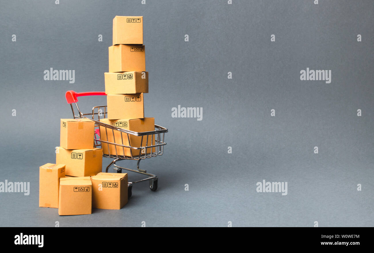 Shopping cart supermarket with boxes. Sales of products. The concept commerce, online shopping. E-commerce, sales and sale of goods through online tra Stock Photo