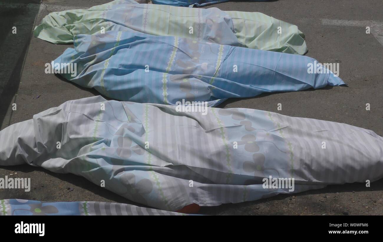 Horror view of dead corpses of mannequins, wrapped in hospital sheets, lie in parking lot morgue at Haemek Hospital during drill. Afula, Israel, April 27th, 2017. Stock Photo