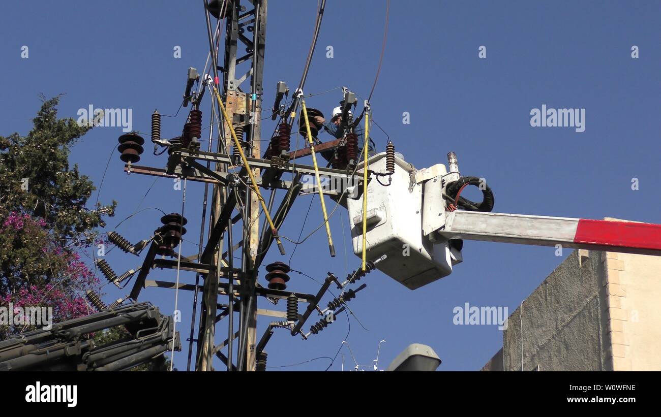 Electricians of the Israeli Electric Co fixing high voltage electrical ...