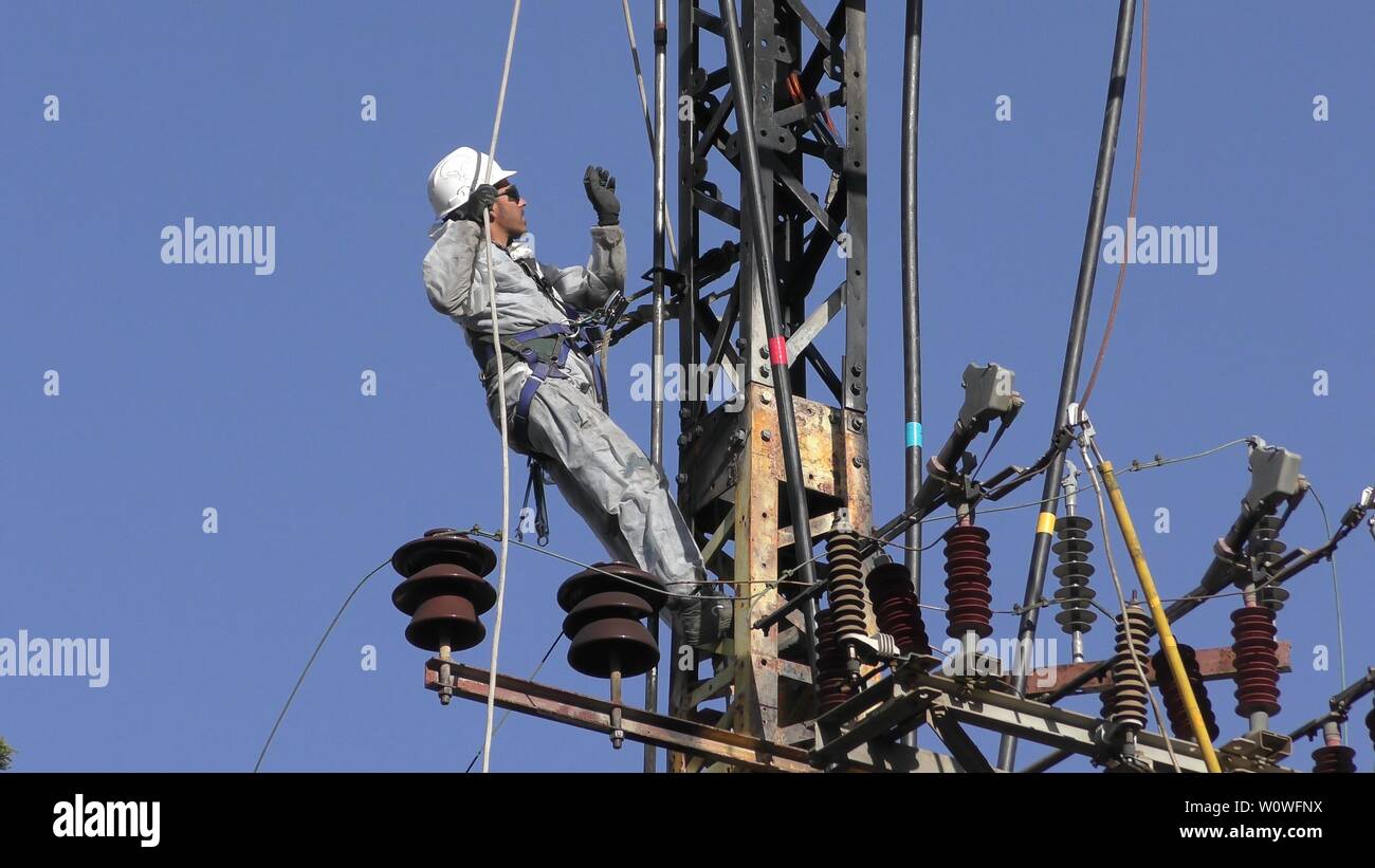 Electricians of the Israeli Electric Co fixing high voltage electrical lines, replacing a
