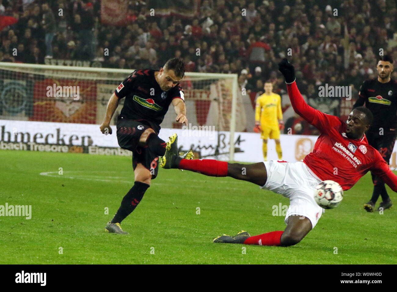 v. li. im Zweikampf   Amir Abrashi (Freiburg) vs Jean-Philippe Mateta (FSV Mainz 05),   1. BL: 18-19: 28. Sptg. - FSV Mainz 05 vs. SC Freiburg  DFL REGULATIONS PROHIBIT ANY USE OF PHOTOGRAPHS AS IMAGE SEQUENCES AND/OR QUASI-VIDEO  Foto: Joachim Hahne/johapress 1. BL: 18-19: 28. Sptg. - FSV Mainz 05 vs. SC Freiburg Stock Photo