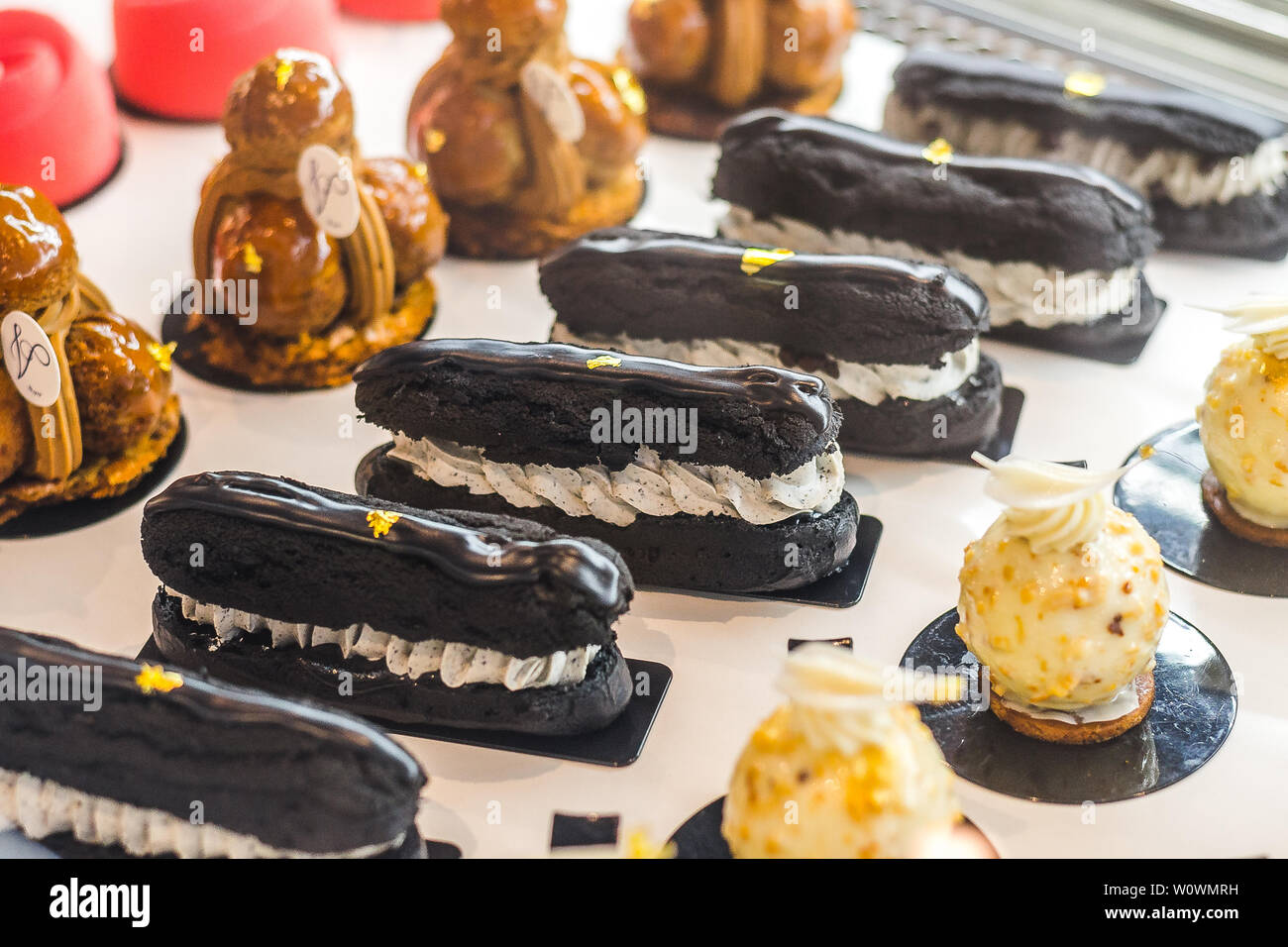assorted beautiful French pastries and desserts on display for sale