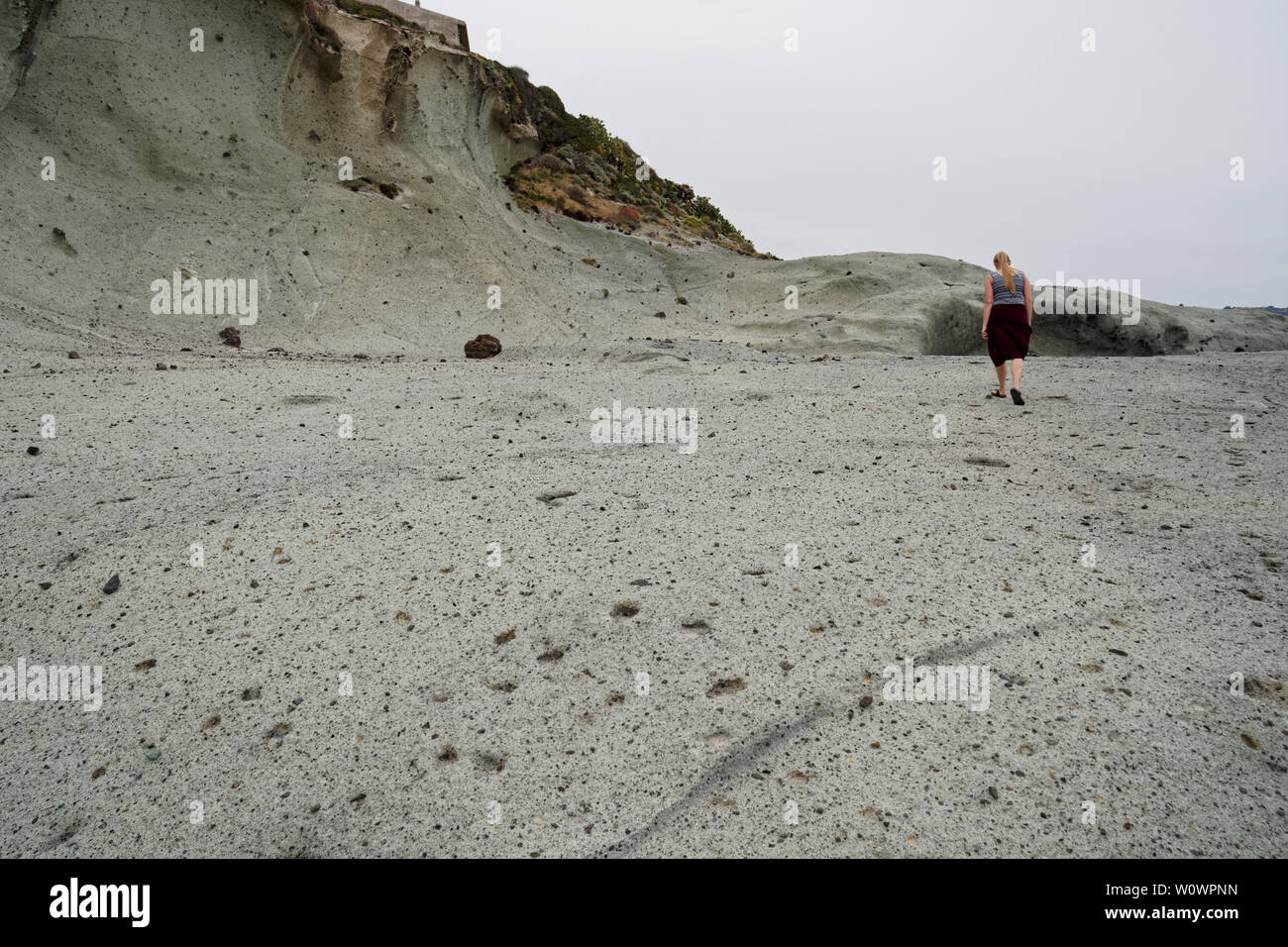 Women walking along the surreal vulcanic moon landscape (vulcanic ground) Cane Malu at Bosa in Italy (Sardegna) Stock Photo
