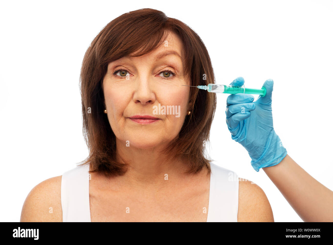 senior woman and surgeon hand with syringe Stock Photo