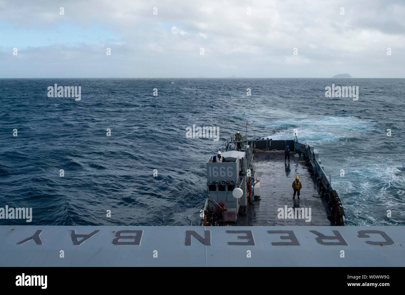 190627-N-DX072-1109 CORAL SEA (June 27, 2019) Landing Craft, Utility (LCU) 1666, assigned to Naval Beach Unit (NBU) 7, approaches the well deck of the amphibious transport dock ship USS Green Bay (LPD 20). Green Bay, part of the Wasp Amphibious Ready Group, with embarked 31st Marine Expeditionary Unit, is operating in the Indo-Pacific region to enhance interoperability with partners and serve as a ready-response force for any type of contingency, while simultaneously providing a flexible and lethal crisis response force ready to perform a wide range of military operations. (U.S. Navy photo by Stock Photo