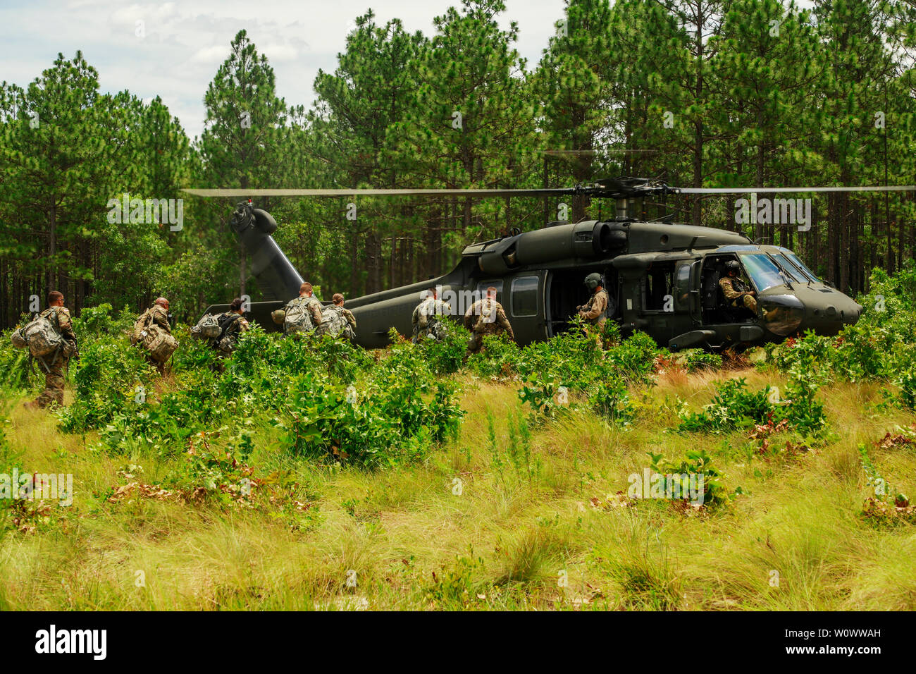 U.S. Army Reserve Soldiers board a UH-60 Blackhawk leaving an Access Control Point event representing multiple commands at the 2019 U.S. Army Reserve Best Warrior Competition at Fort Bragg, N.C. June 26, 2019. This year’s Best Warrior Competition will determine the top noncommissioned officer and junior enlisted Soldier who will represent the U.S. Army Reserve in the Department of the Army Best Warrior Competition later this year at Fort A.P. Hill, Va. (U.S. Army Reserve photo by Spc. Cody Roberts) (Released) Stock Photo