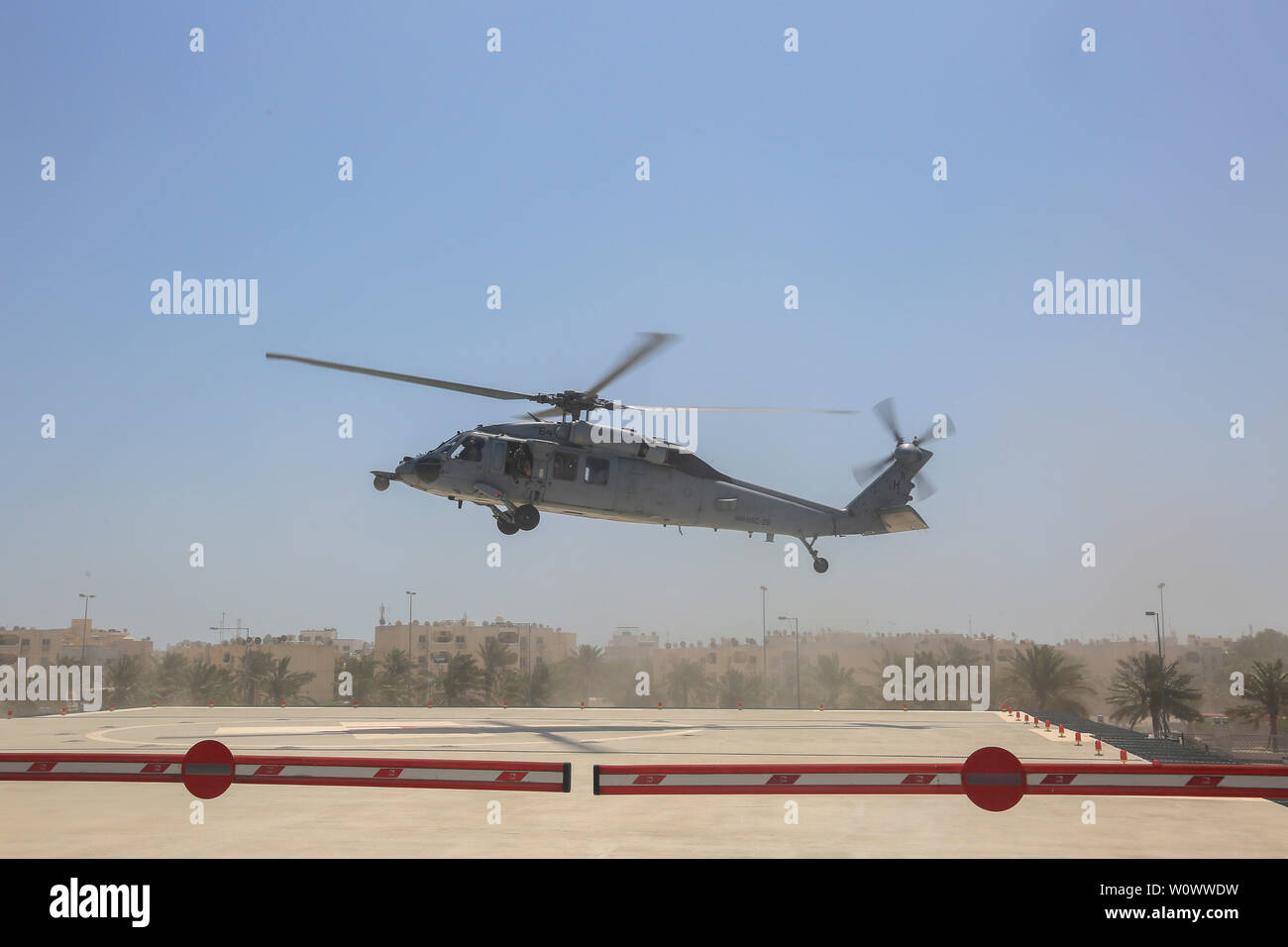 190619-A-ET280-1022 AL SAYH, Bahrain (June 19, 2019) A U.S. Navy MH-60 Sea Hawk helicopter lands on the helicopter landing zone at the Kingdom Hamad University Hospital (KHUH) during a medical evacuation training. U.S. Naval Forces Central Command and KHUH routinely practice medical evacuation drills to build partnership between nations. (U.S. Army photo by Pfc. Bradley McKinely/Released) Stock Photo