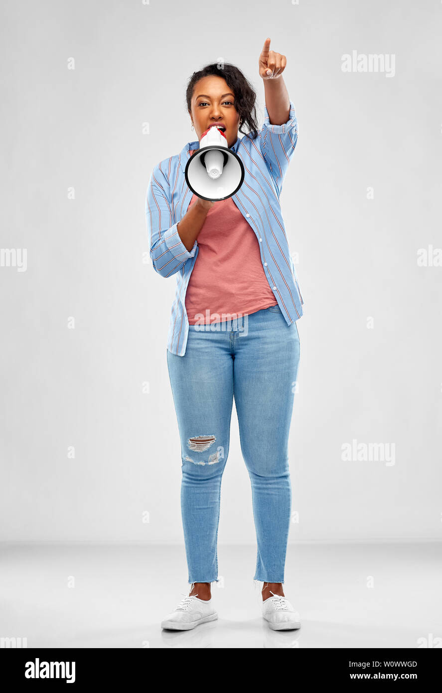happy african american woman over grey background Stock Photo - Alamy
