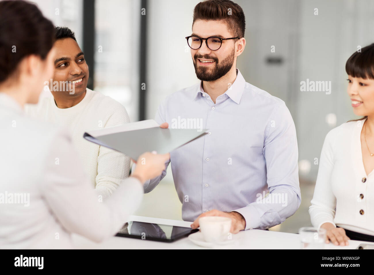 Employee giving folder happy hi-res stock photography and images - Alamy