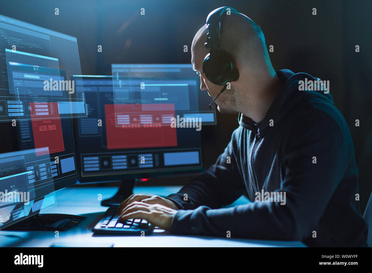 hacker with access denied messages on computers Stock Photo