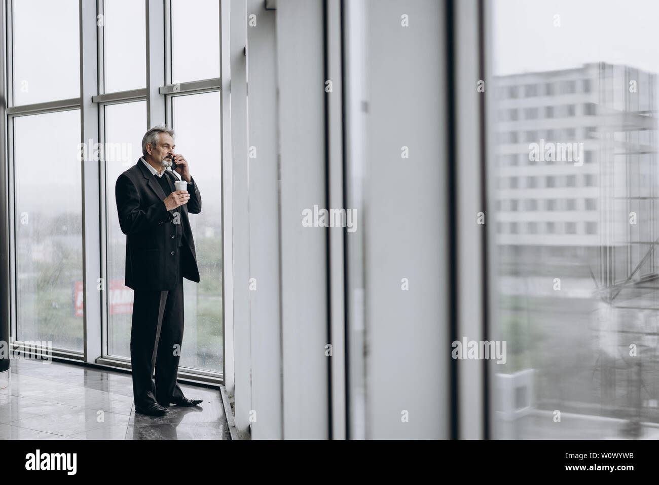 Serious elder man in big office centre Stock Photo