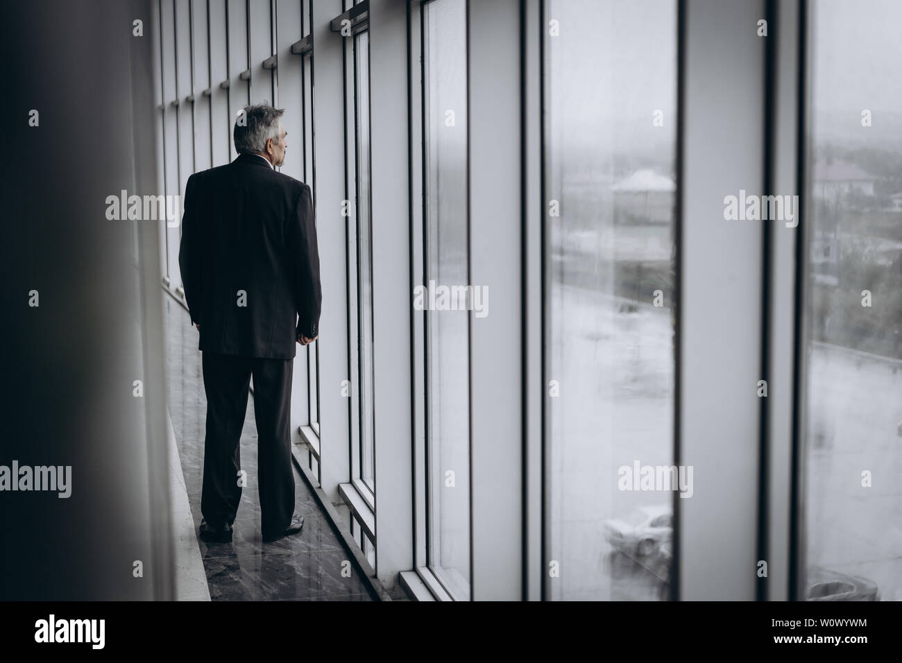 Serious elder man in big office centre Stock Photo