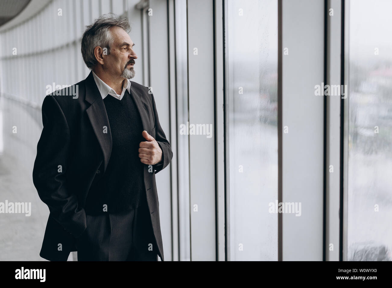 Serious elder man in big office centre Stock Photo