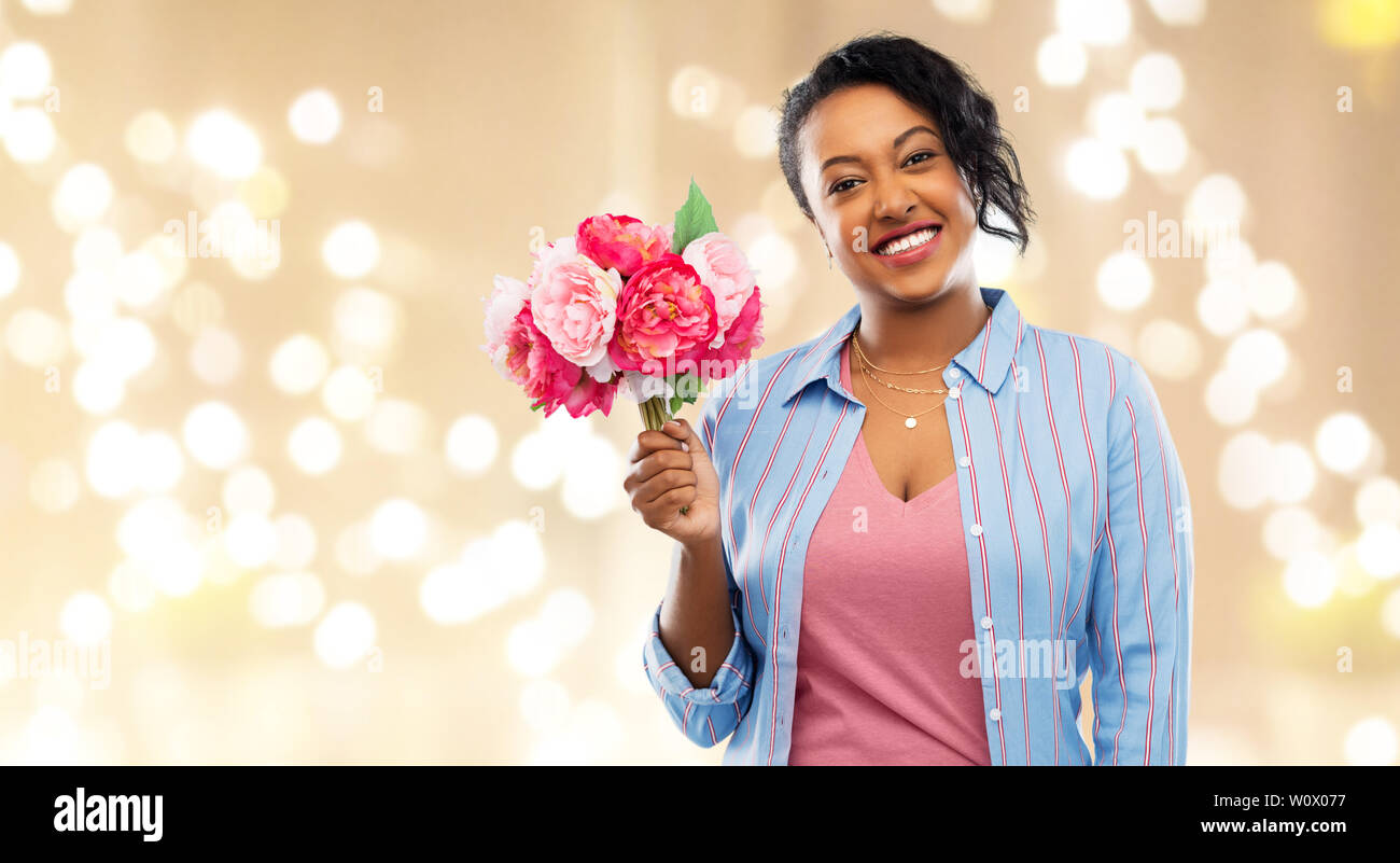 happy african american woman with bunch of flowers Stock Photo - Alamy