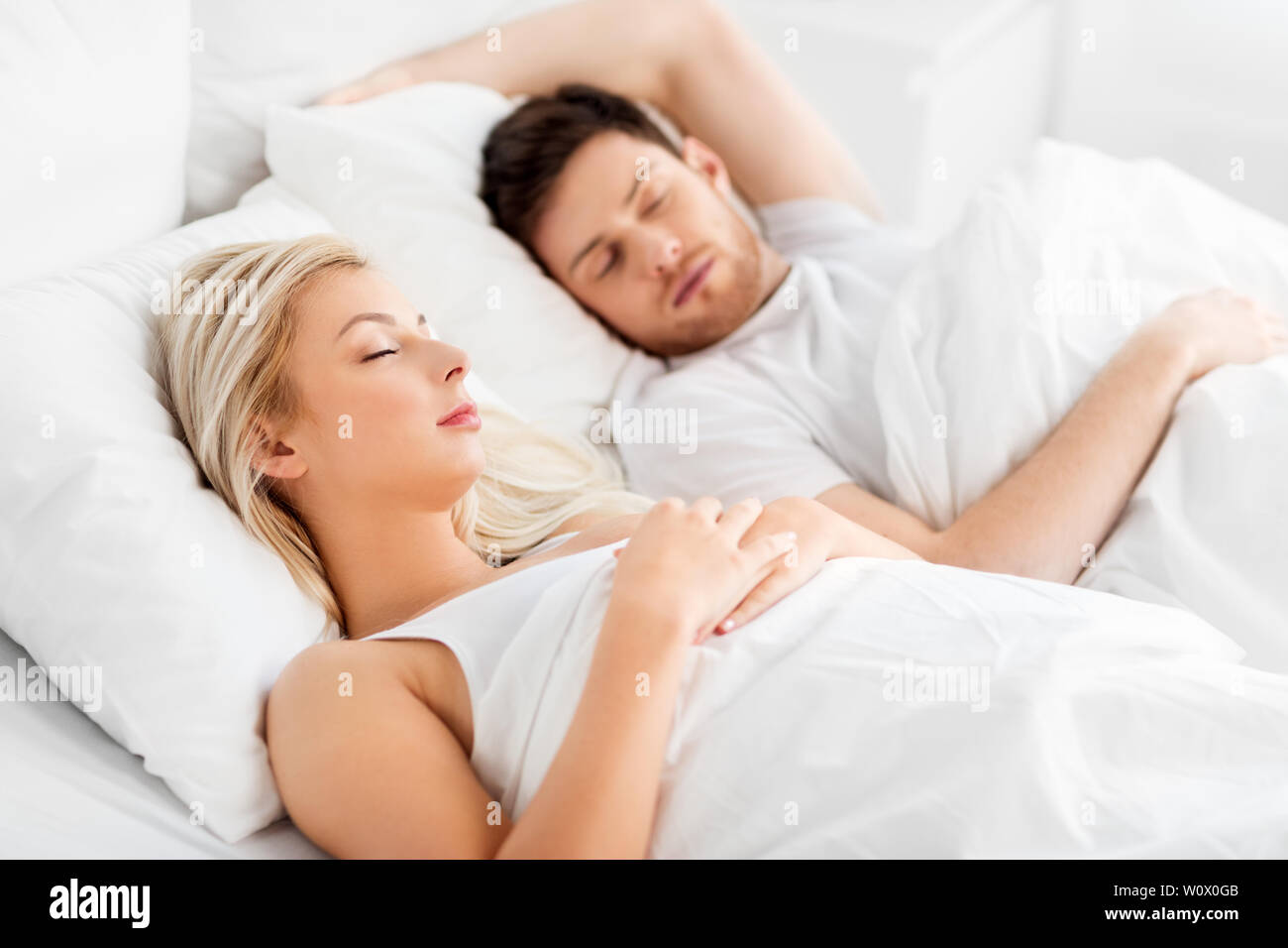 happy couple sleeping in bed at home Stock Photo - Alamy