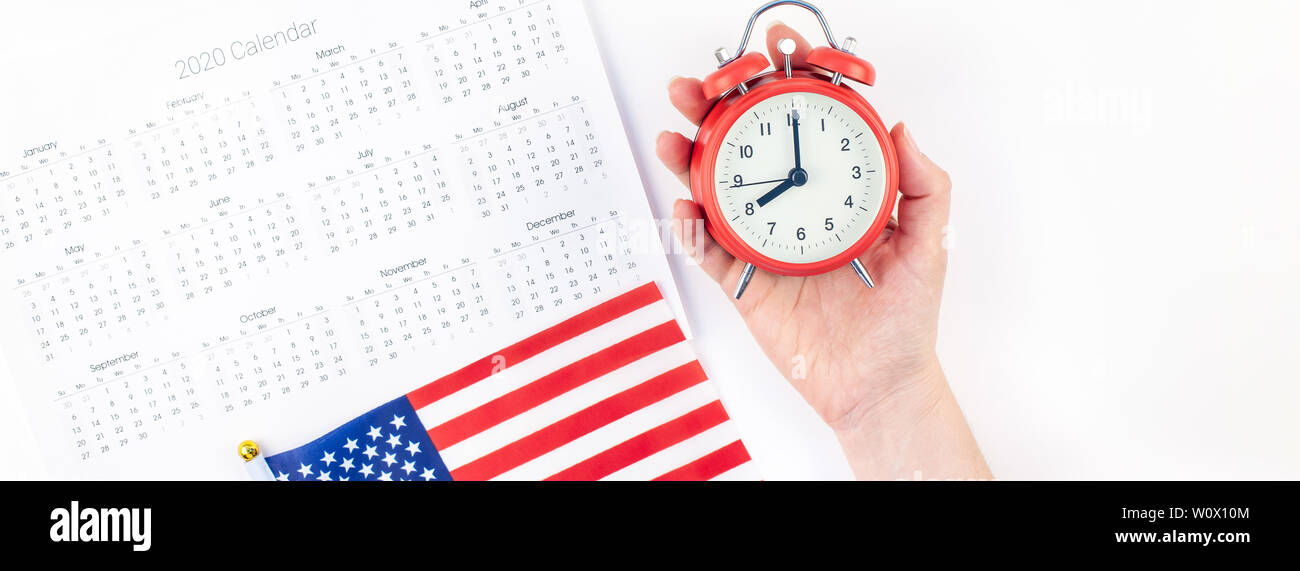 Creative top view flat lay of American flags for Elections, Memorial Day 4th of July or Labour Day with calendar copy space on white background in min Stock Photo