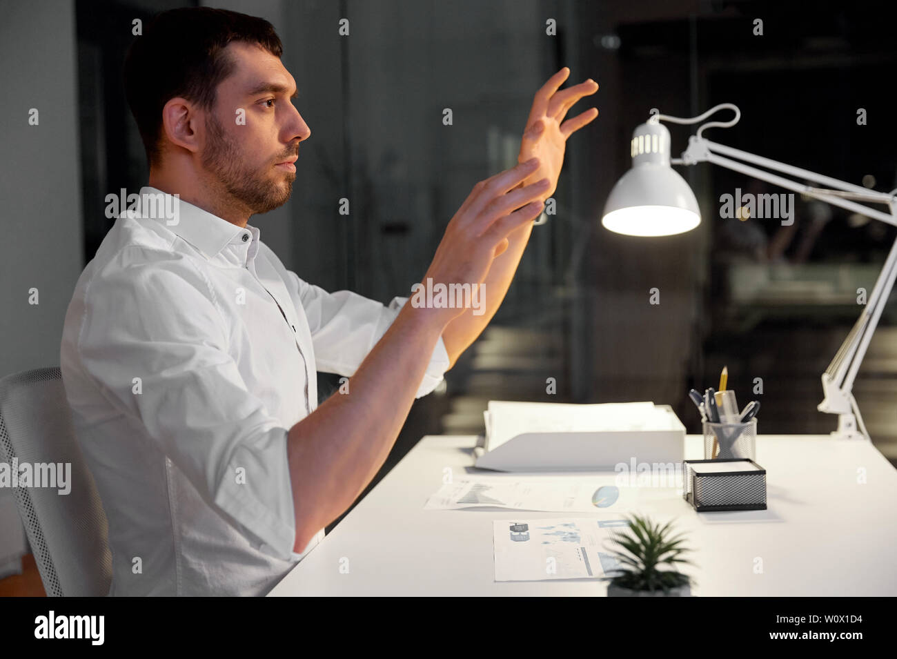 businessman using gestures at night office Stock Photo