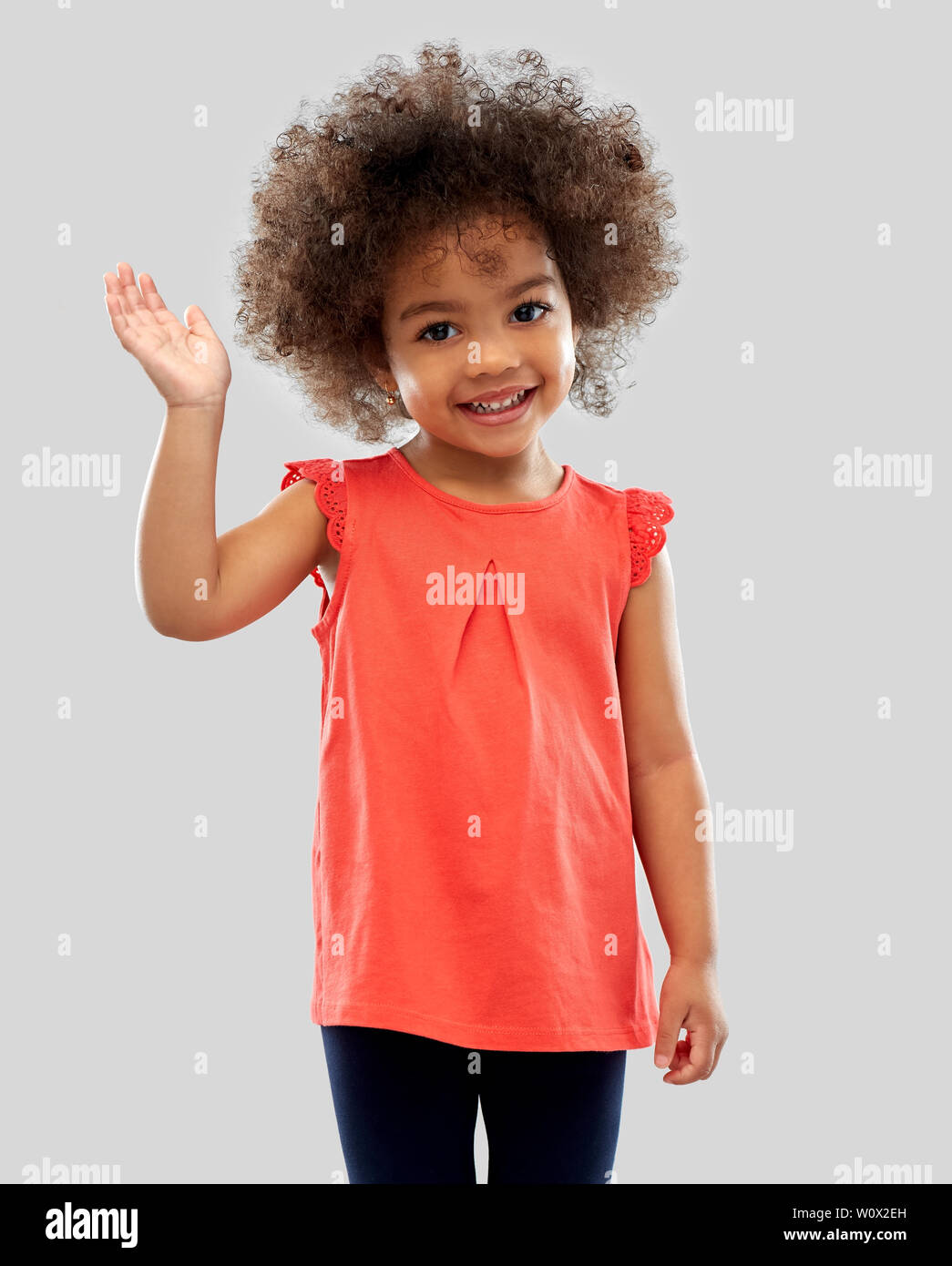 happy little african american girl waving hand Stock Photo - Alamy