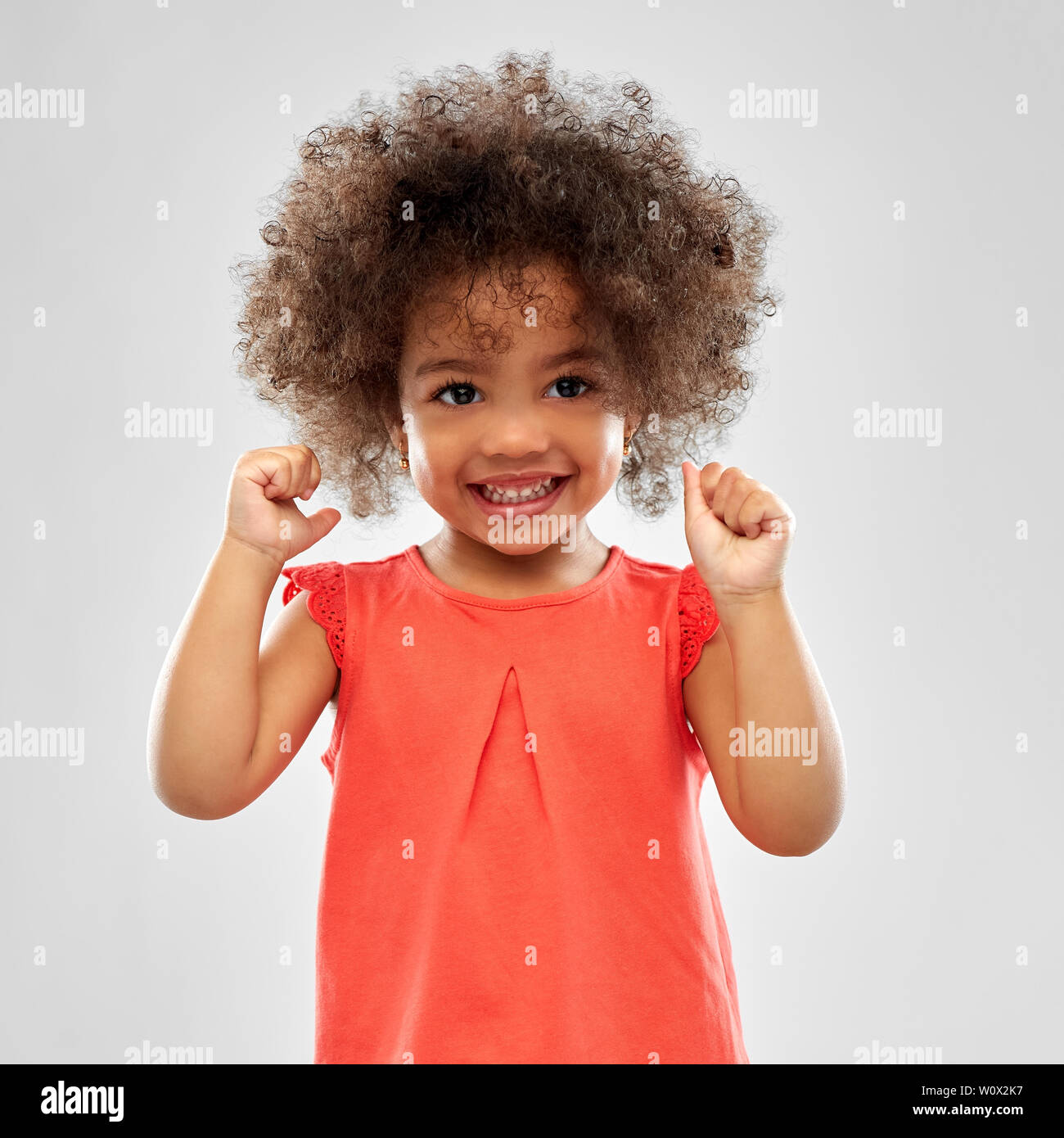 happy little african american girl over grey Stock Photo - Alamy