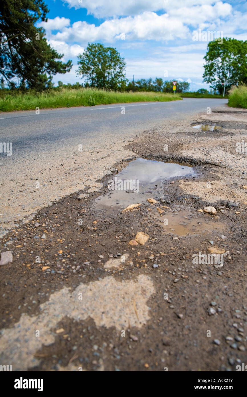 Pothole. Oxford roads. Road damaged by erosion and weather. Potholes