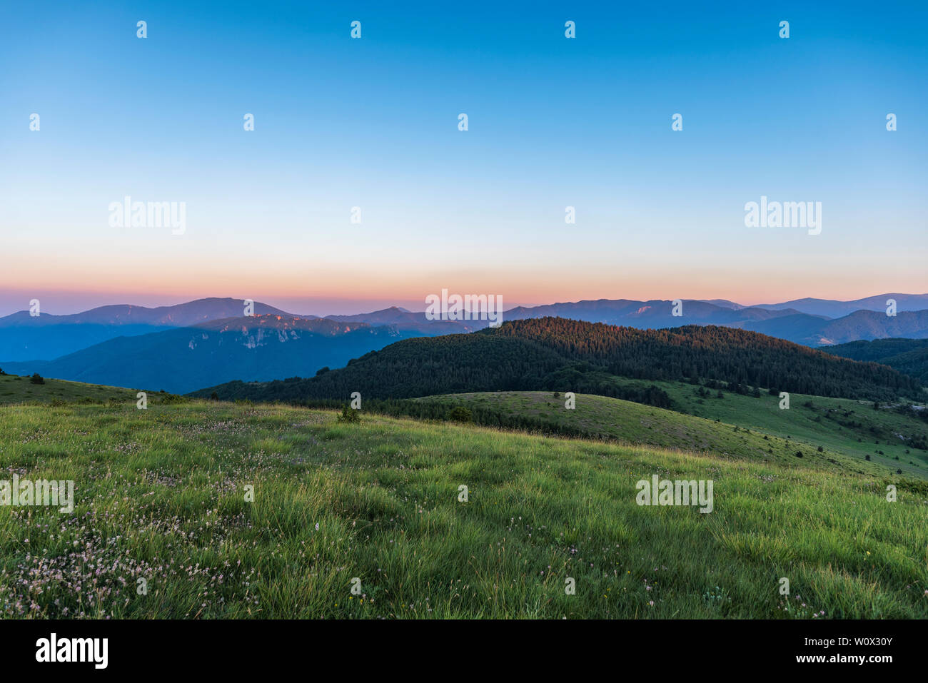 Amazing mountain landscape with colorful vivid sunset on clear sky ...