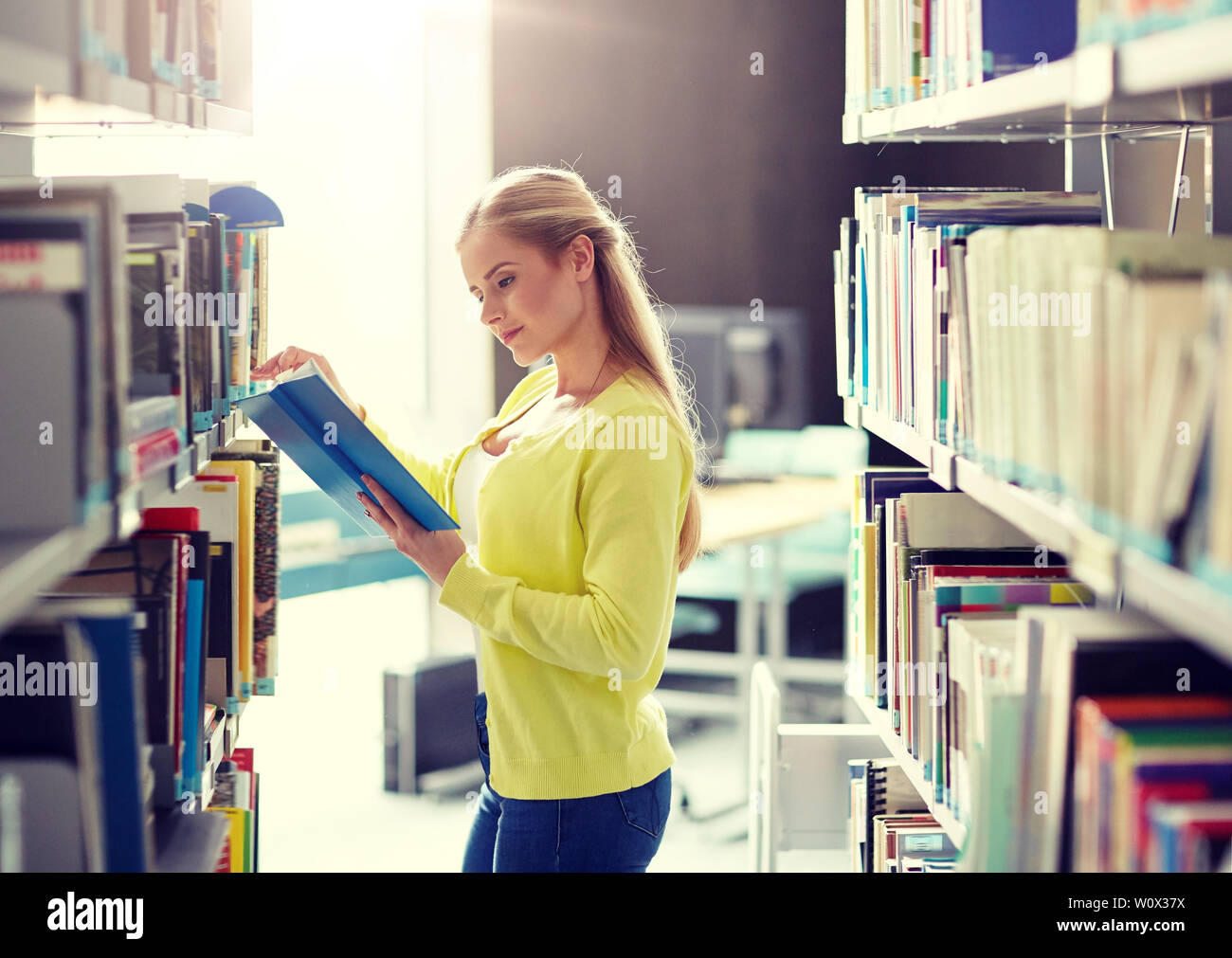 high school student girl reading book at library Stock Photo - Alamy