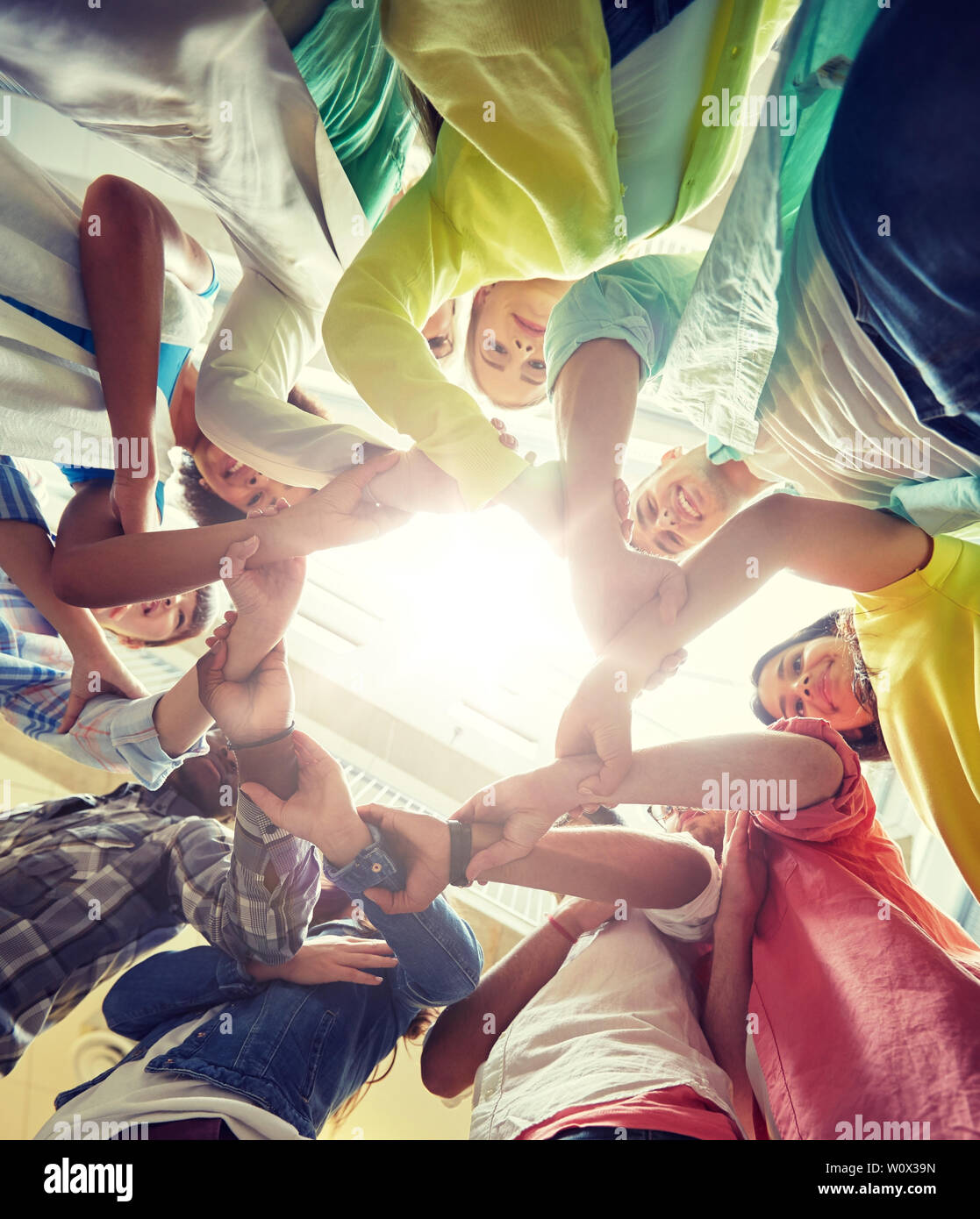 group of international students holding hands Stock Photo - Alamy