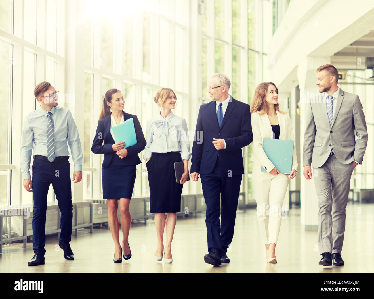 business people walking along office building Stock Photo - Alamy