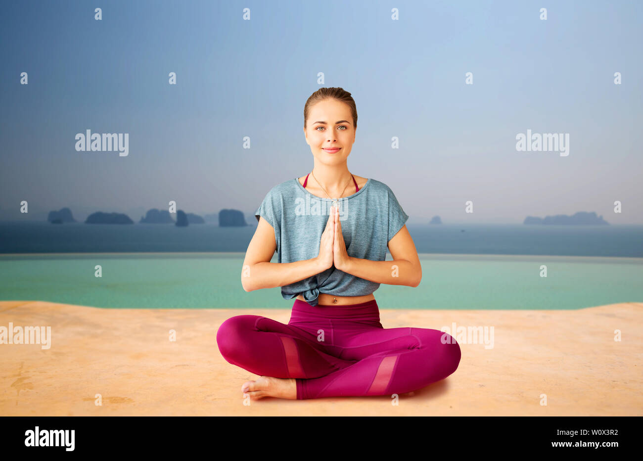 woman doing yoga and meditating in lotus pose Stock Photo - Alamy