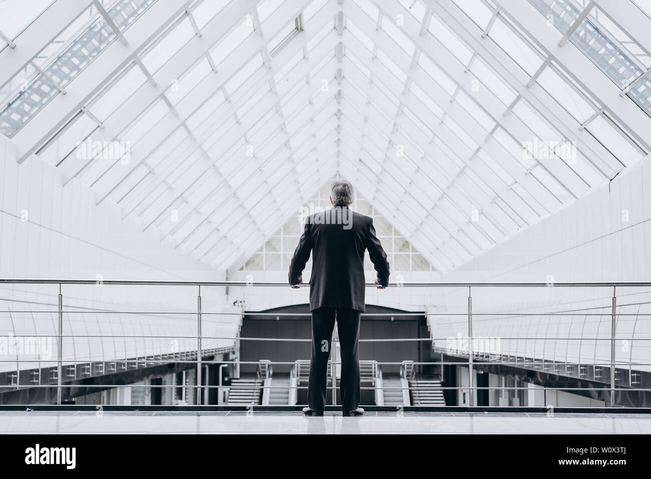 Serious elder man in big office centre Stock Photo