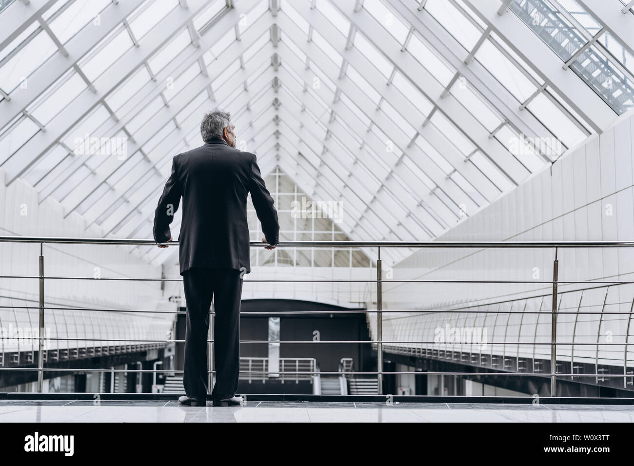 Serious elder man in big office centre Stock Photo