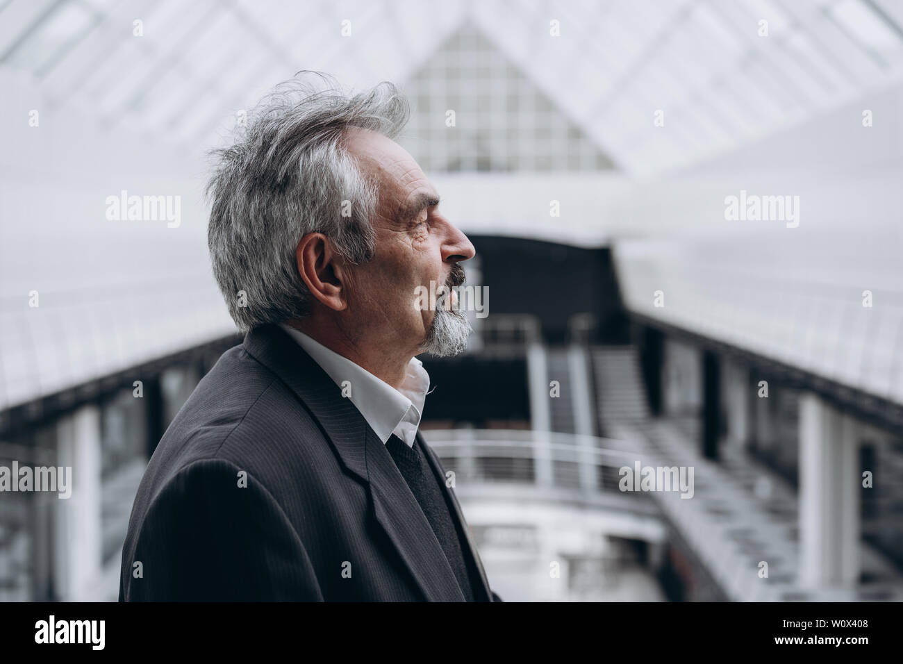 Serious elder man in big office centre Stock Photo