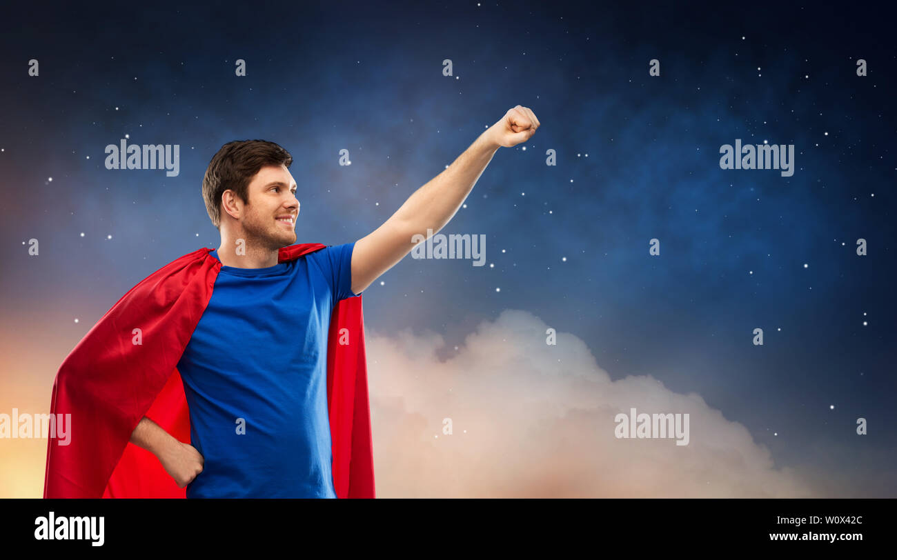 man in red superhero cape over night sky Stock Photo - Alamy