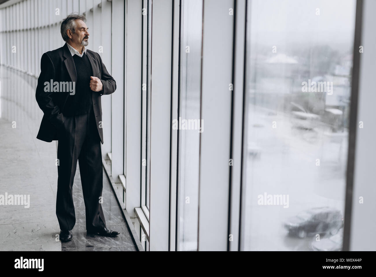 Serious elder man in big office centre Stock Photo