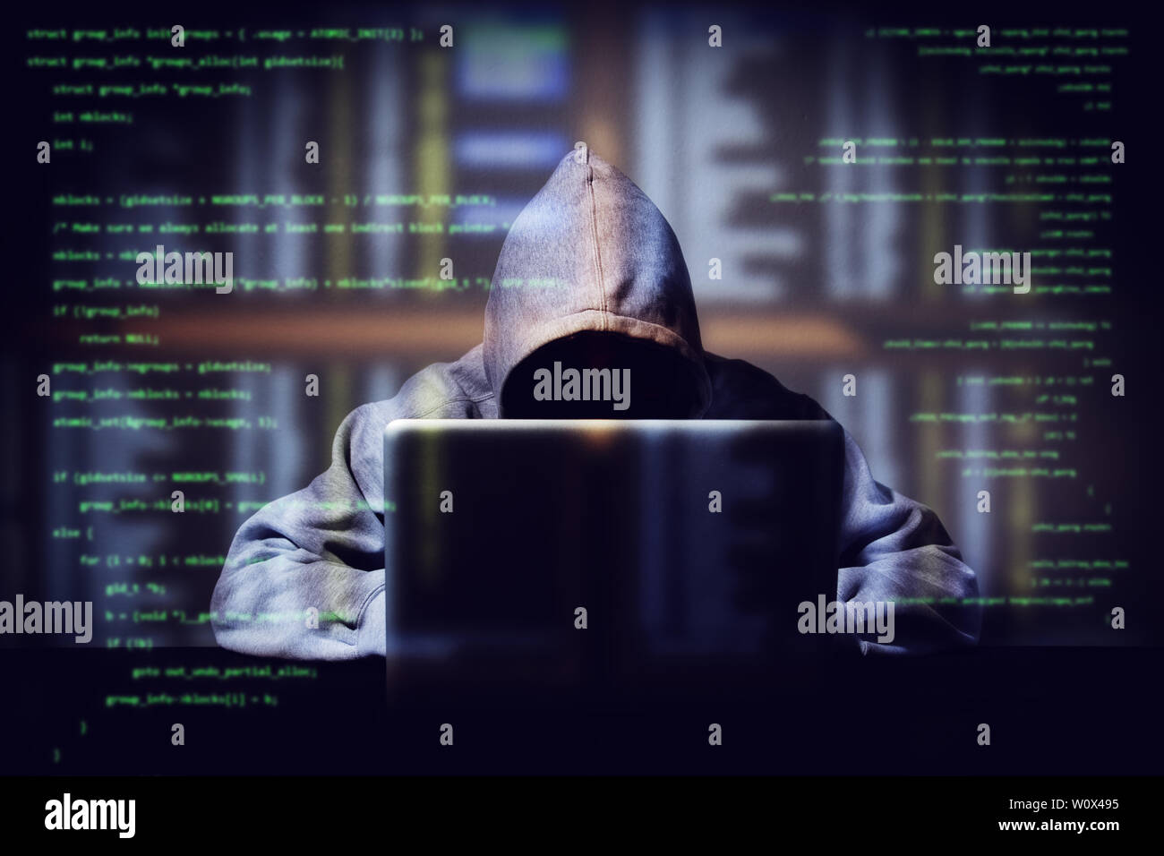 hacker working on a computer code with laptop, double exposure with digital interface around at background. internet crime , hacking and malware conce Stock Photo