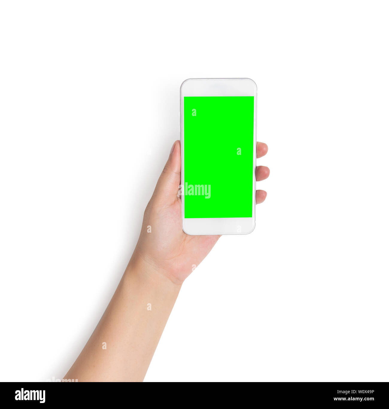 hand holding white mobile smart phone with blank green screen isolated on white background with clipping path on green screen and background, studio s Stock Photo
