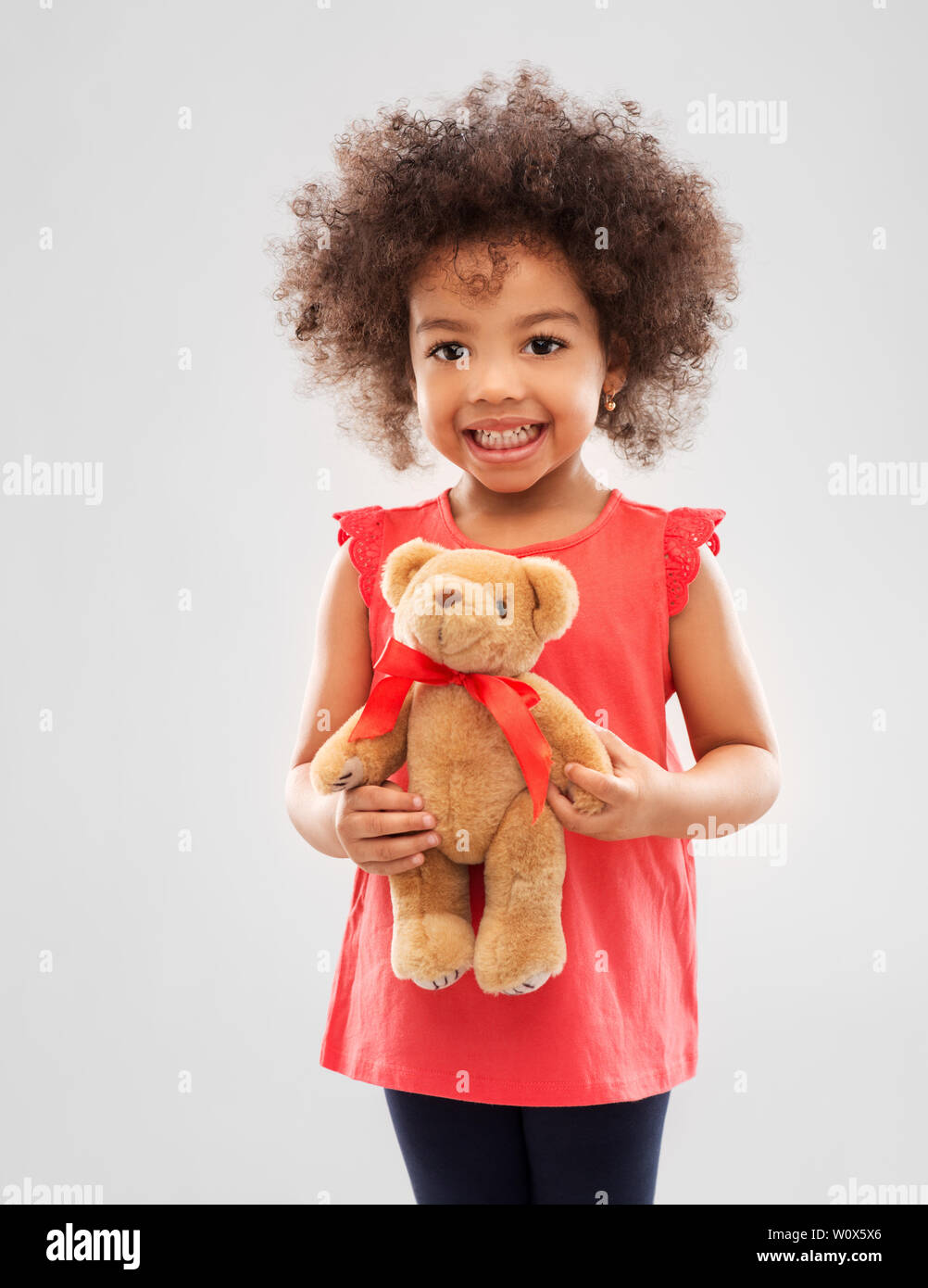 happy little african american girl with teddy bear Stock Photo - Alamy