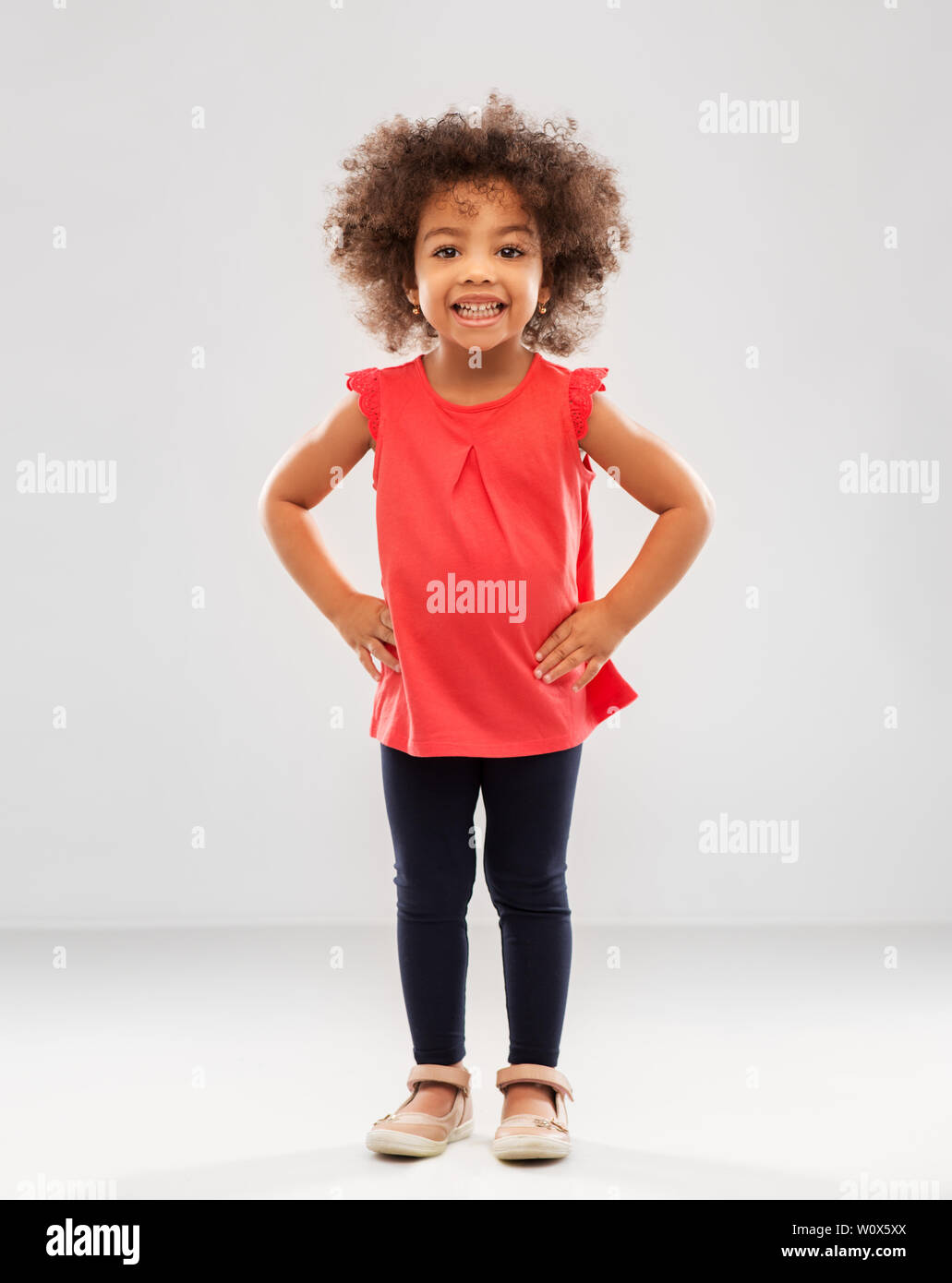 happy little african american girl over grey Stock Photo - Alamy
